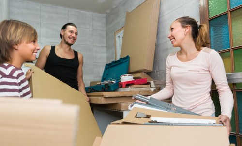 Removal team carrying out safe lifting procedures during a house move