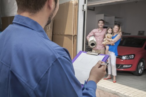Moving team handling furniture in a Lambeth residential street