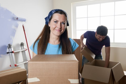 Office furniture and boxes being moved through a local building