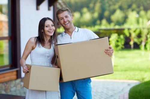 Mover using PPE while handling household items during relocation