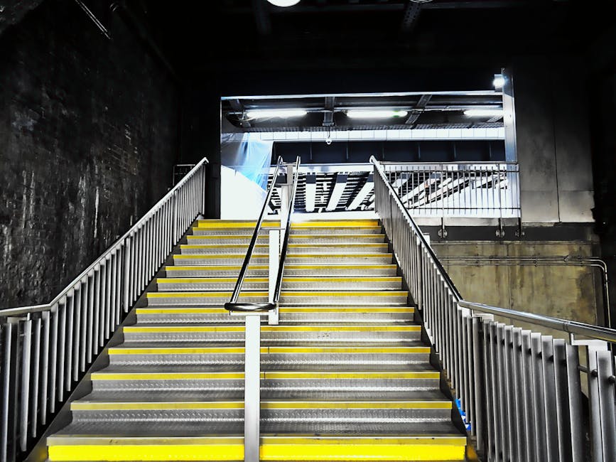 The image shows a staircase inside a residential property, with a marble or stone ramp providing stair access. The staircase features a dark wooden handrail and white balustrades, leading up to a smal